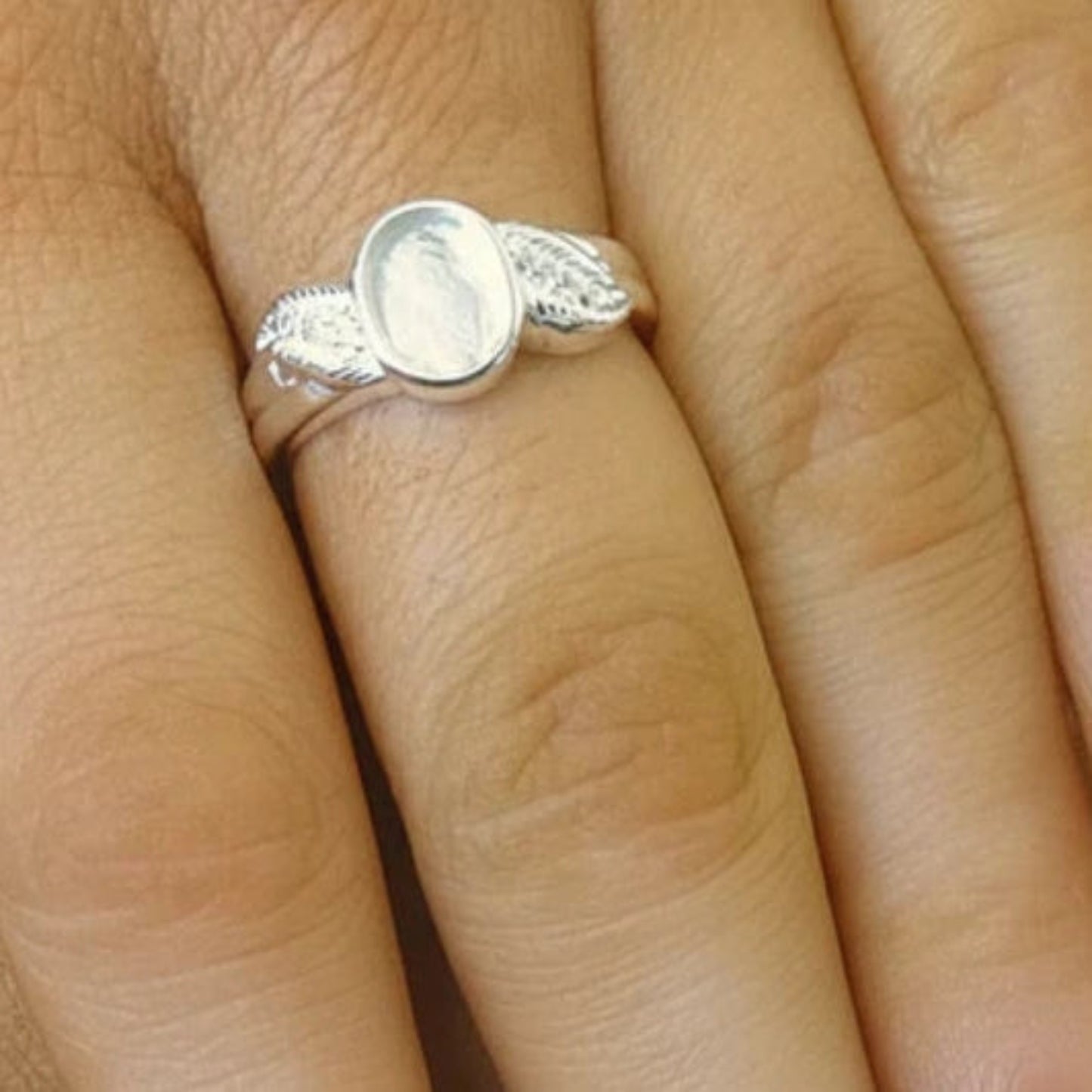Forever Feather Ring worn on finger — silver oval feather ashes memorial ring, handcrafted in the UK