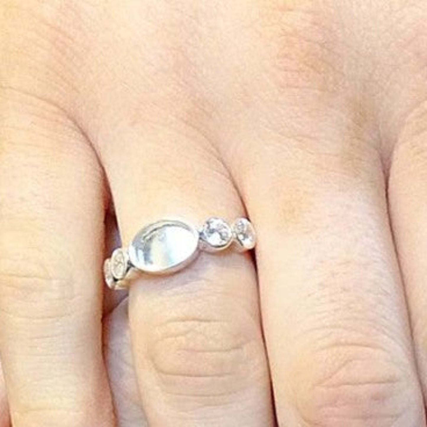 Arcadia Ring worn on hand — silver oval keepsake ashes memorial ring, handcrafted in the UK