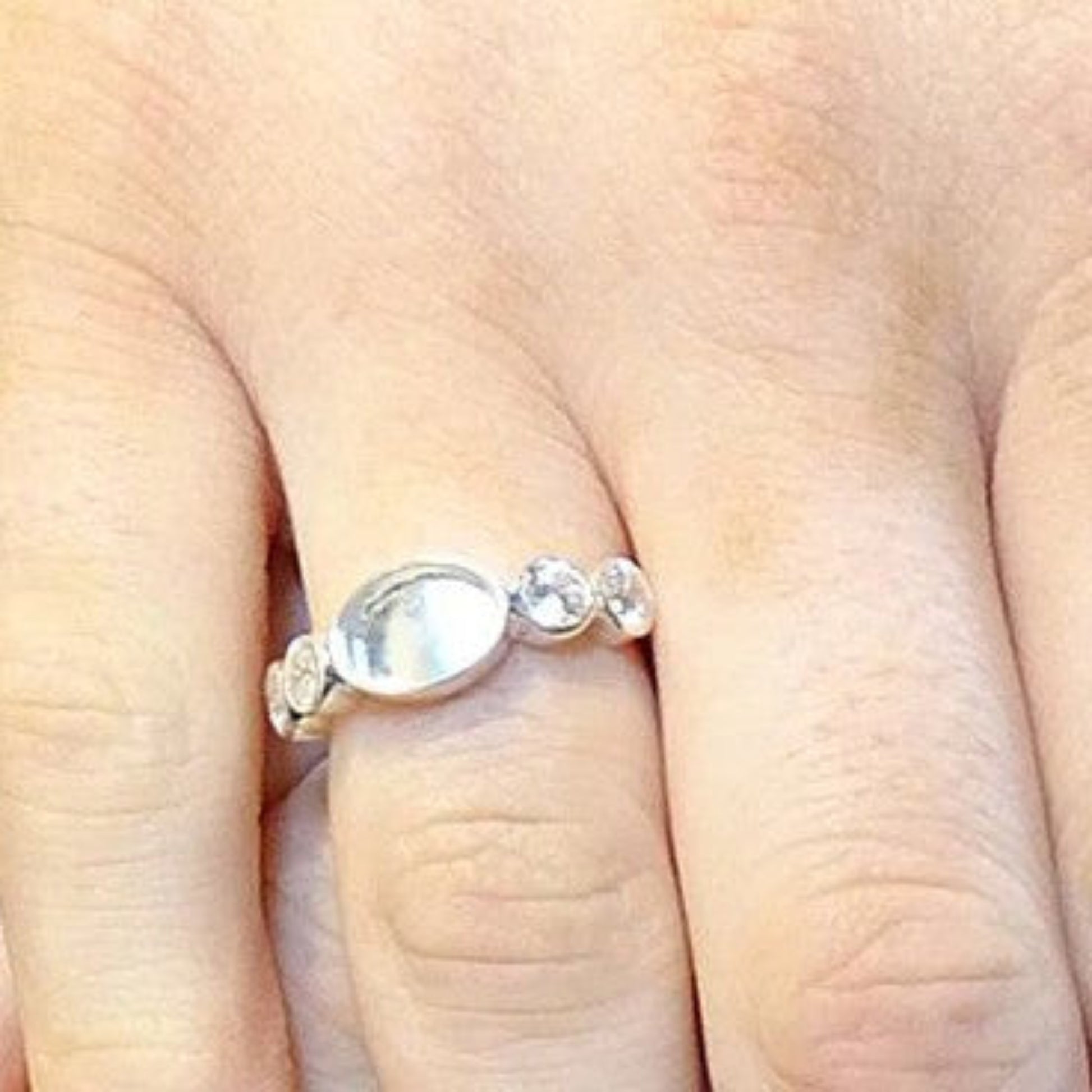 Arcadia Ring worn on hand — silver oval keepsake ashes memorial ring, handcrafted in the UK