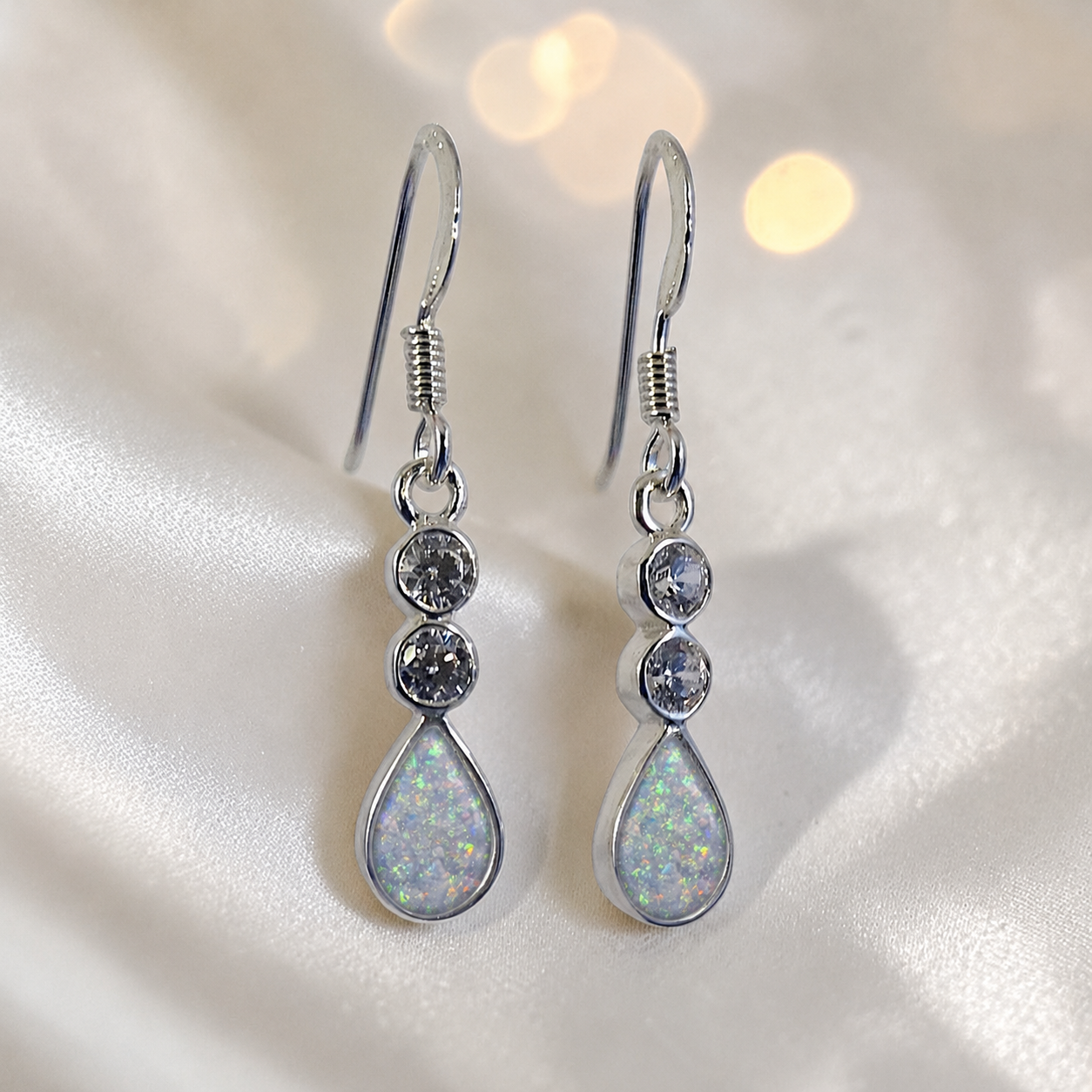 Acrux Earrings — silver pear drop ashes memorial earrings in White Snow resin, handcrafted in Lancashire, UK