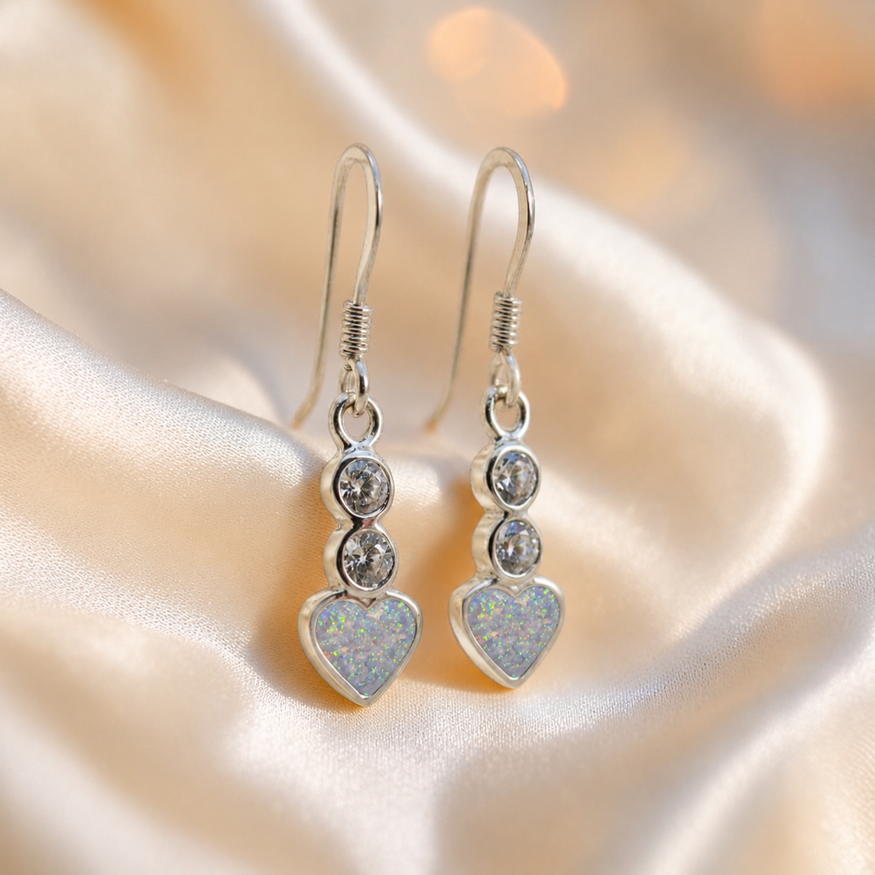 Pleione Earrings — silver heart drop ashes memorial earrings in White Snow resin, handcrafted in Lancashire, UK