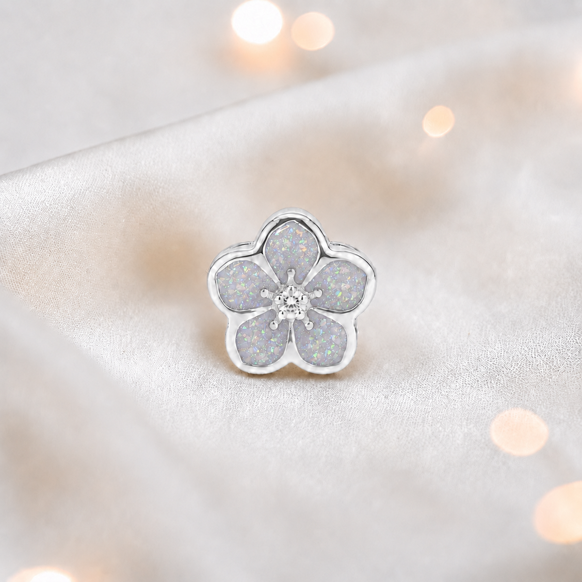 White snow sterling silver forget me not ashes memorial charm, handcrafted in Lancashire by keepsake memorial
