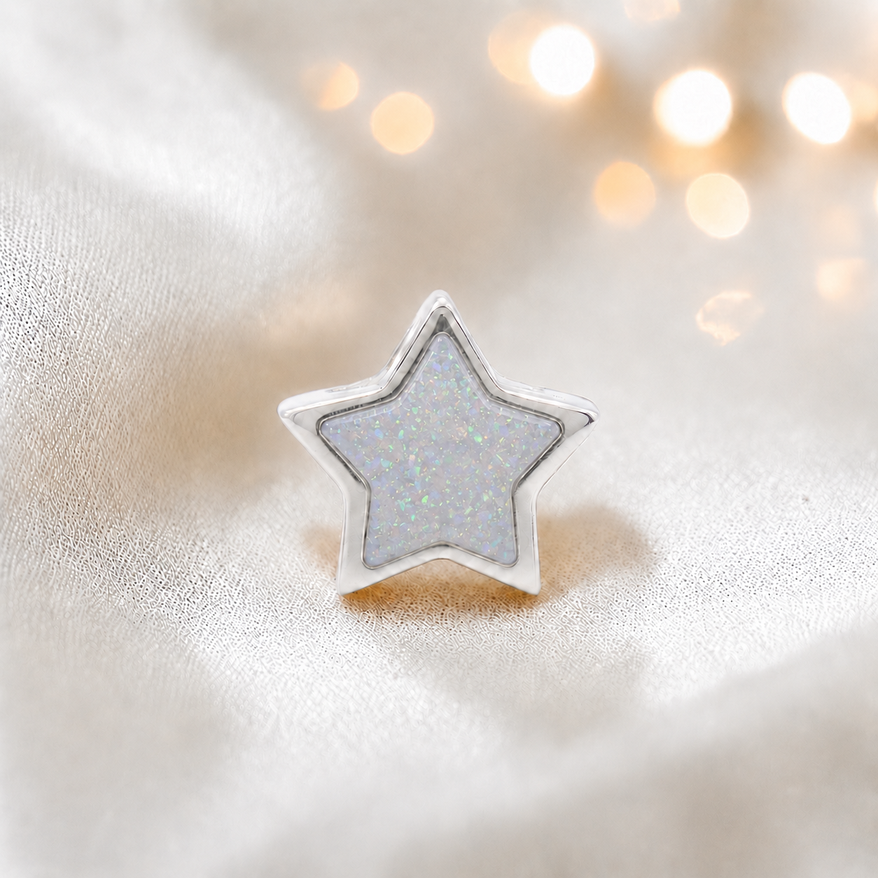 White snow sterling silver star ashes memorial charm, handcrafted in Lancashire by keepsake memorial