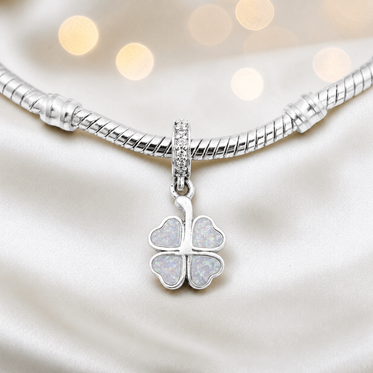 White snow sterling silver clover dangle ashes memorial charm, handcrafted in Lancashire by keepsake memorial