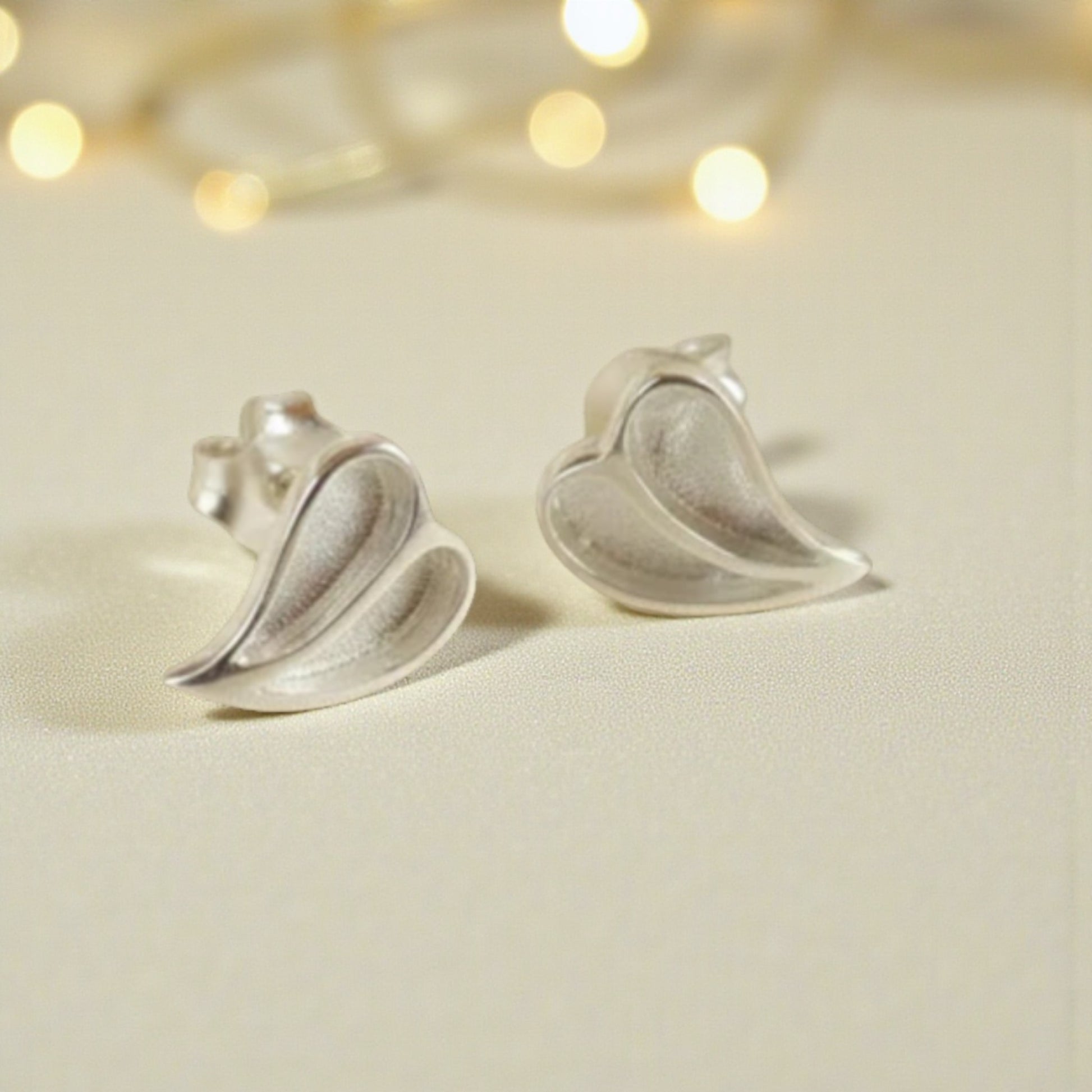 Two Hearts memorial stud earrings — sterling silver split heart ashes earrings, handcrafted in Lancashire, UK