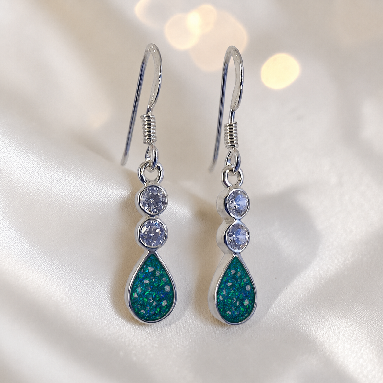 Acrux Earrings — silver pear drop ashes memorial earrings in Teal Mist resin, handcrafted in Lancashire, UK