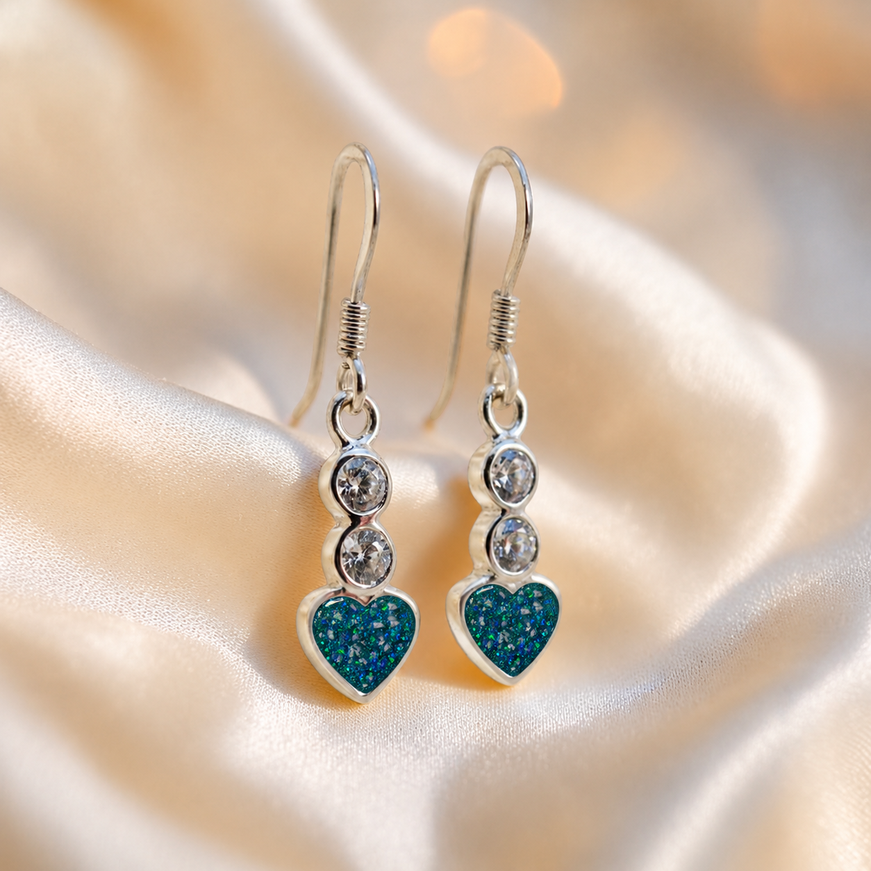 Pleione Earrings — silver heart drop ashes memorial earrings in Teal Mist resin, handcrafted in Lancashire, UK