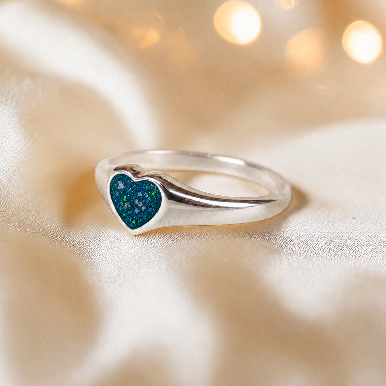 Eden Heart shaped memorial ashes ring in teal mist,  handcrafted in Lancashire, UK.