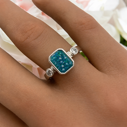 Keepsake Memorial Silver Anastasia Emerald Cut Ashes Ring in Teal Mist on hand — handcrafted in Lancashire, UK