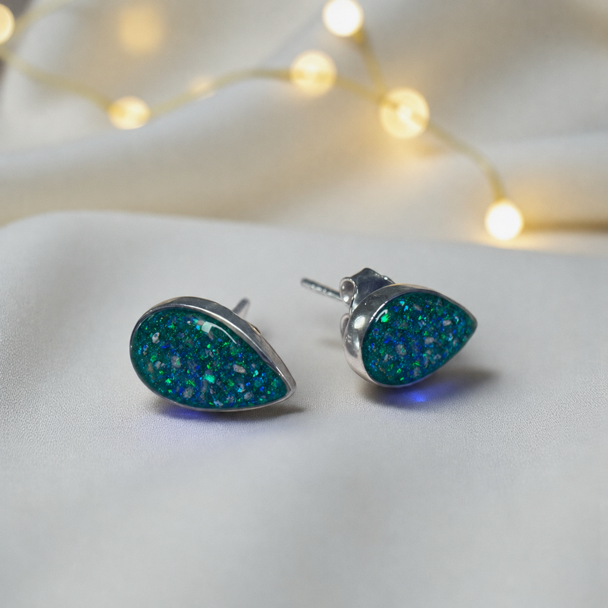 Pure Radiance memorial earrings in Teal Mist opal — sterling silver, handcrafted in Lancashire, UK