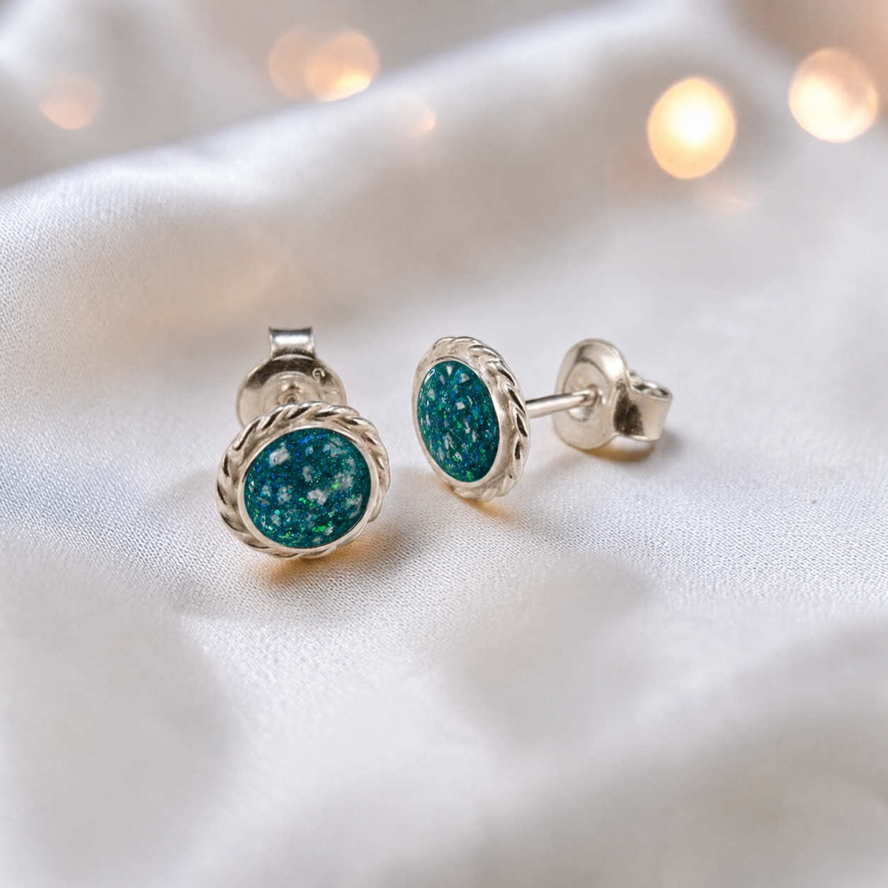 Eterna memorial stud earrings in Teal Mist opal — sterling silver rope edge, handcrafted in Lancashire, UK