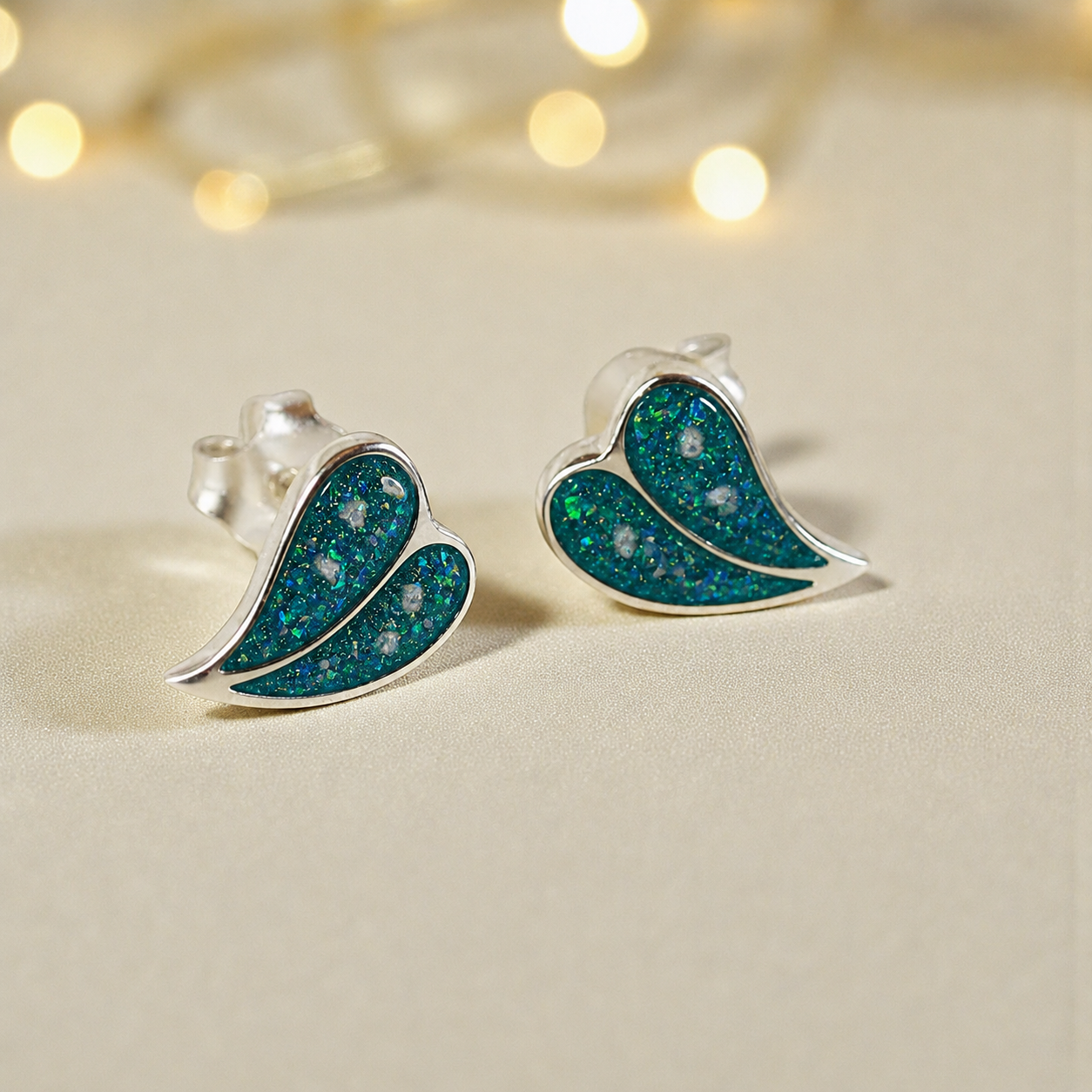 Two Hearts memorial stud earrings in Teal Mist opal — sterling silver, handcrafted in Lancashire, UK