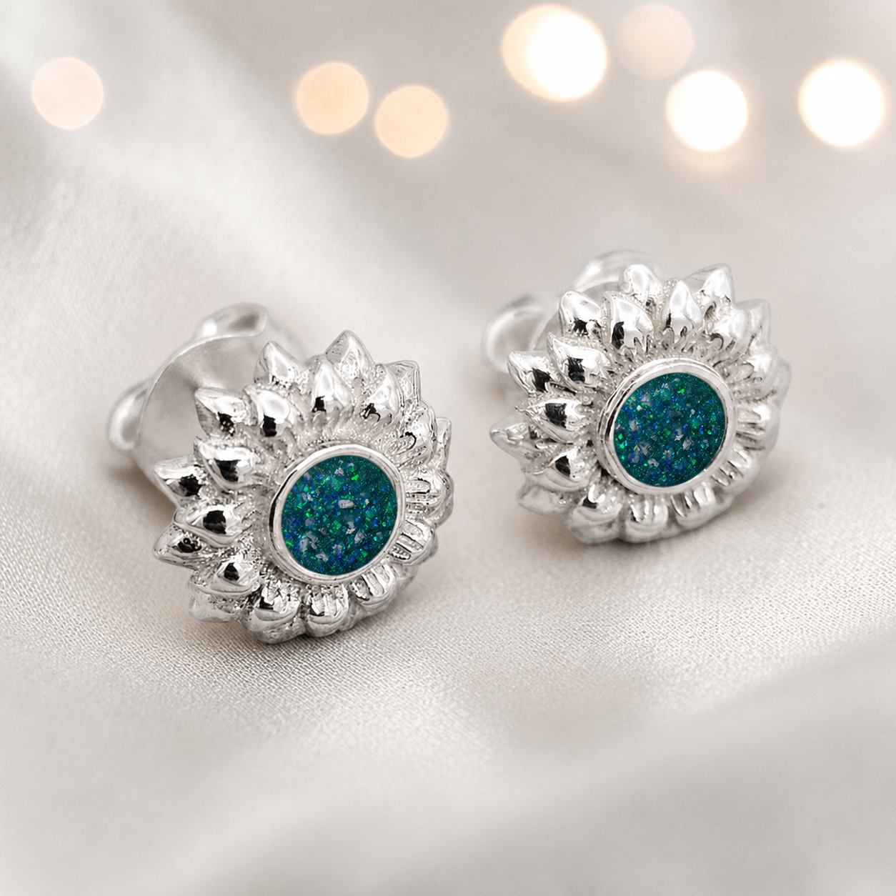 Flora Earrings — silver sunflower ashes memorial stud earrings in Teal Mist resin, handcrafted in Lancashire, UK