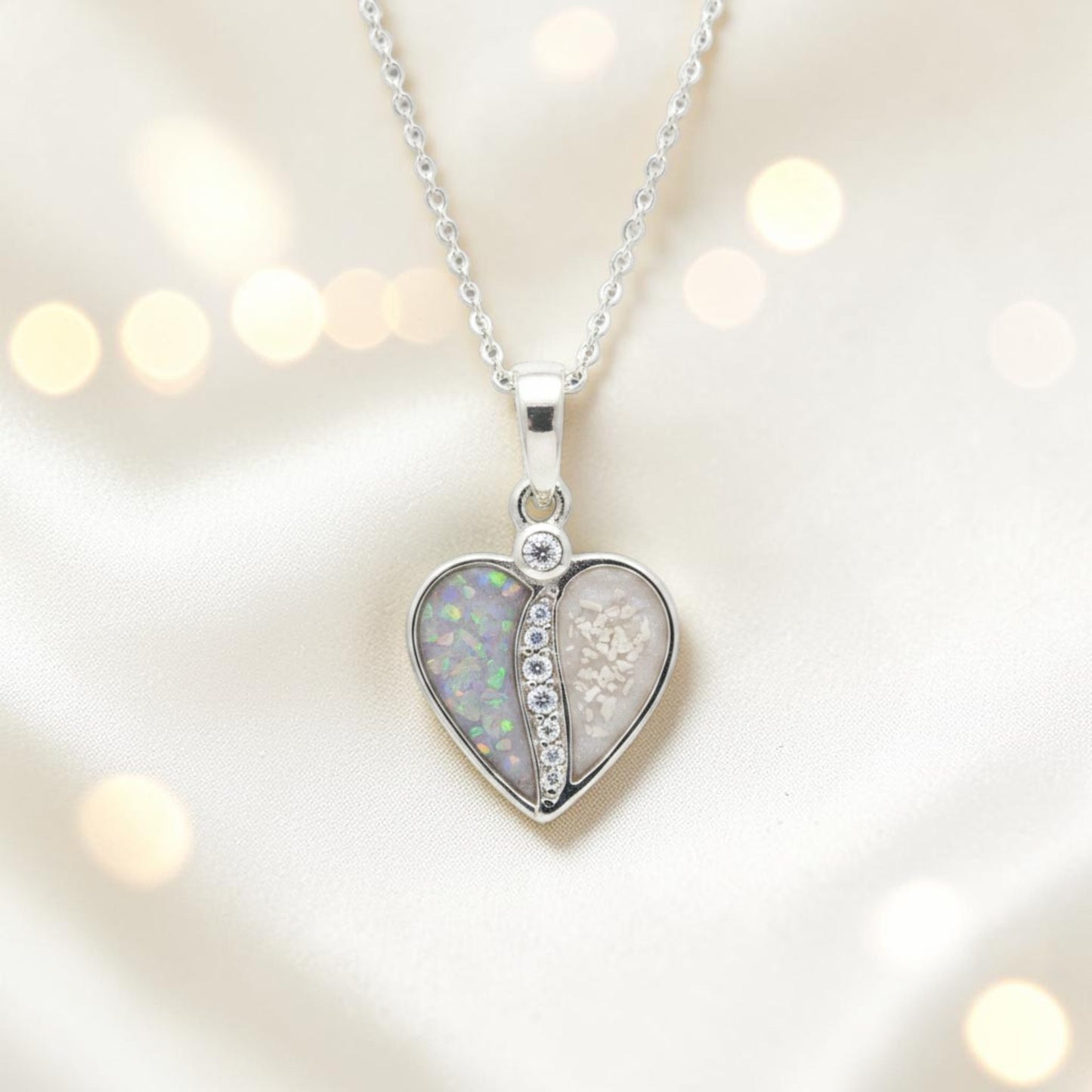 Split heart sterling silver memorial pendant set with cubic zirconia, designed to hold ashes or hair as a keepsake tribute