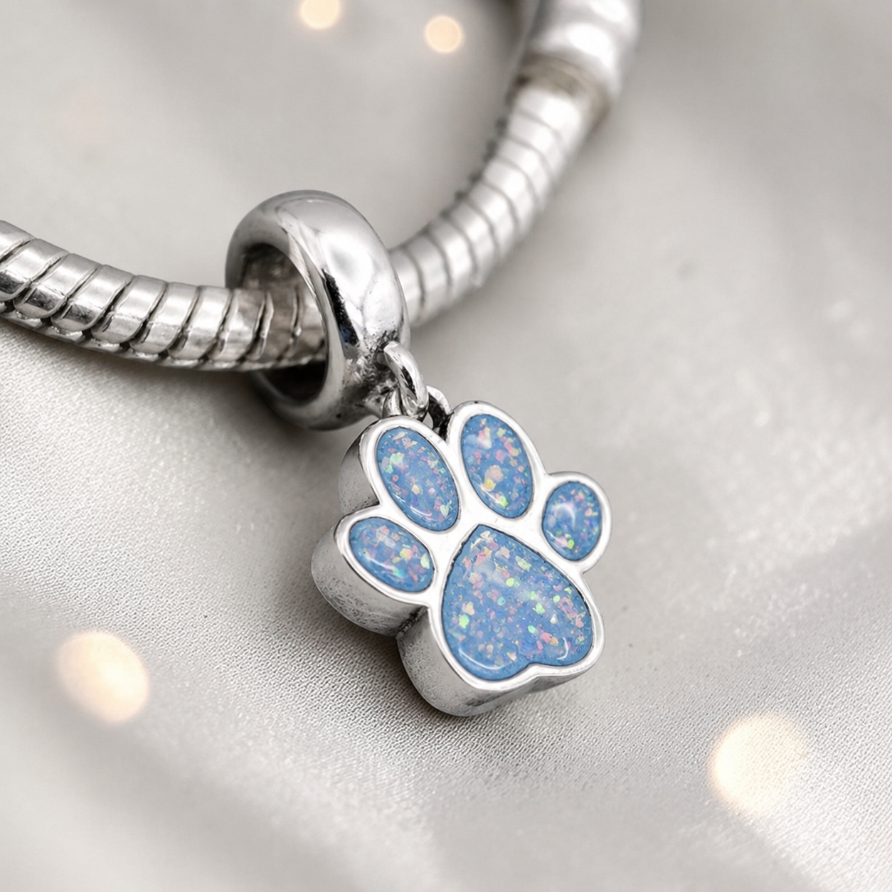 Whiskers dangle paw ashes charm, in baby blue, handcrafted in Lancashire UK - by Keepsake Memorial Jewellery 