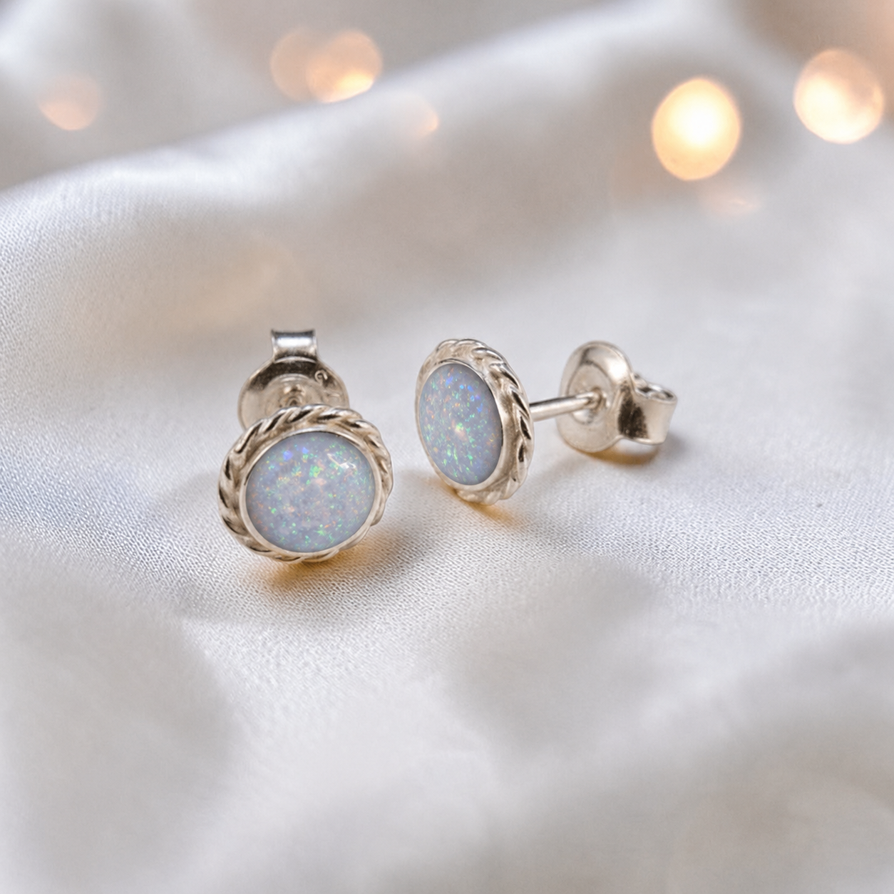 Eterna memorial stud earrings in White Snow opal — sterling silver rope edge, handcrafted in Lancashire, UK