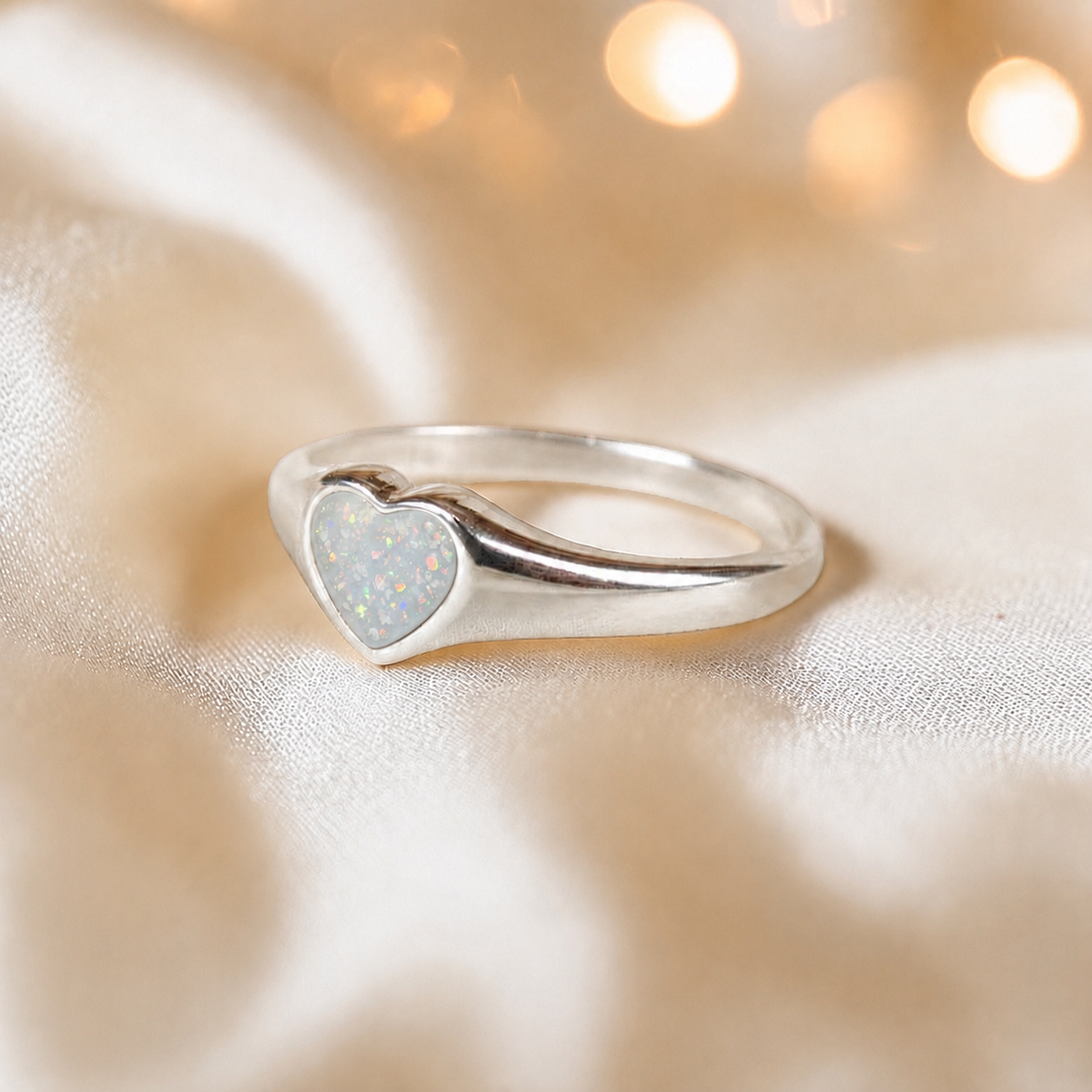 Eden Heart shaped memorial ashes ring in white snow,  handcrafted in Lancashire, UK.