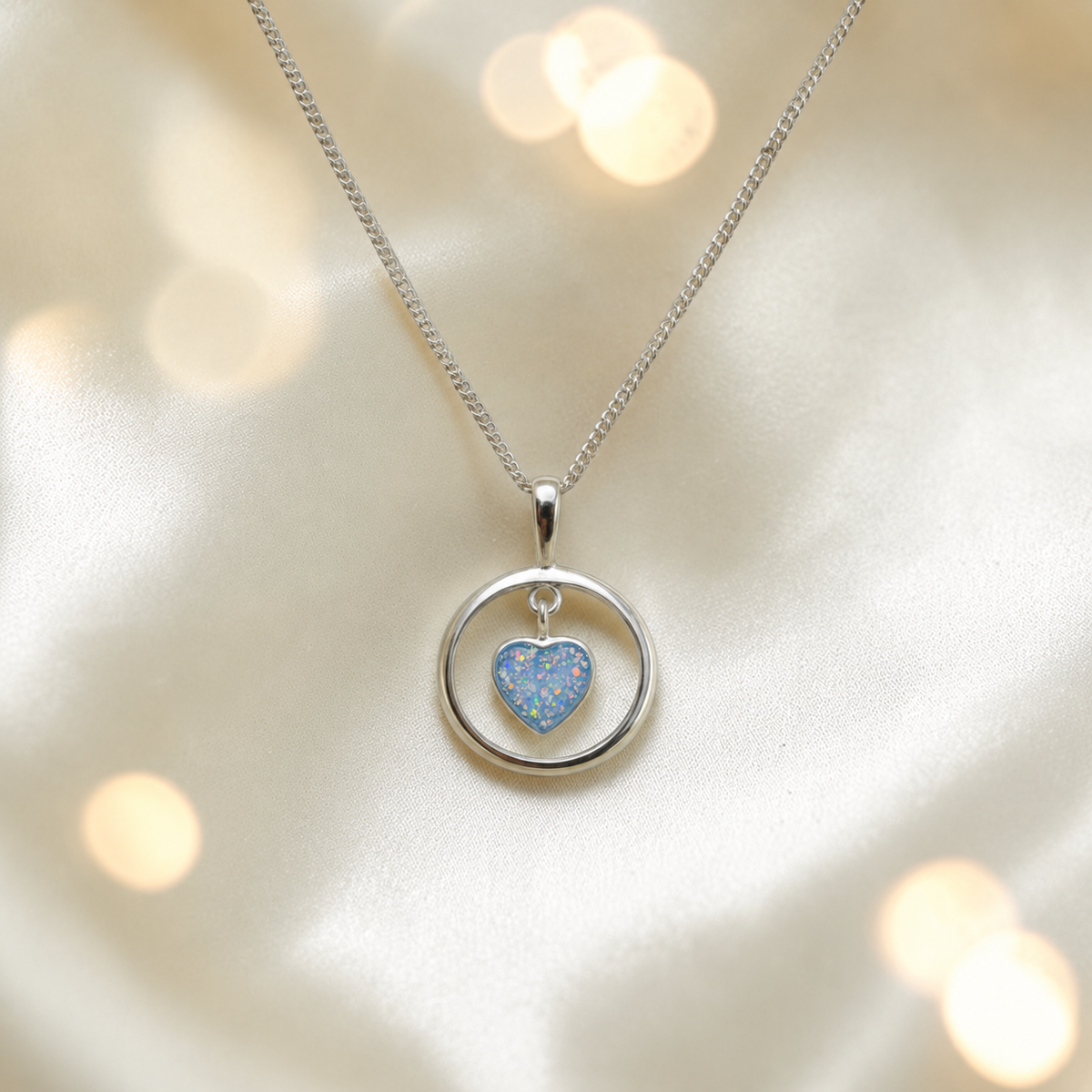 Wren silver open circle with heart drop ashes pendant in baby blue, handcrafted in Lancashire UK