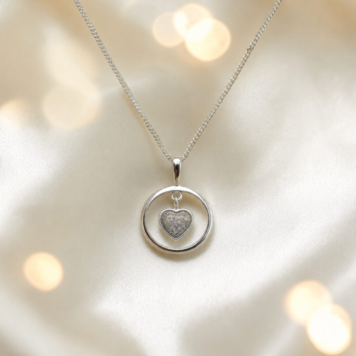 Wren silver open circle with heart drop ashes pendant in natural ash, handcrafted in Lancashire UK