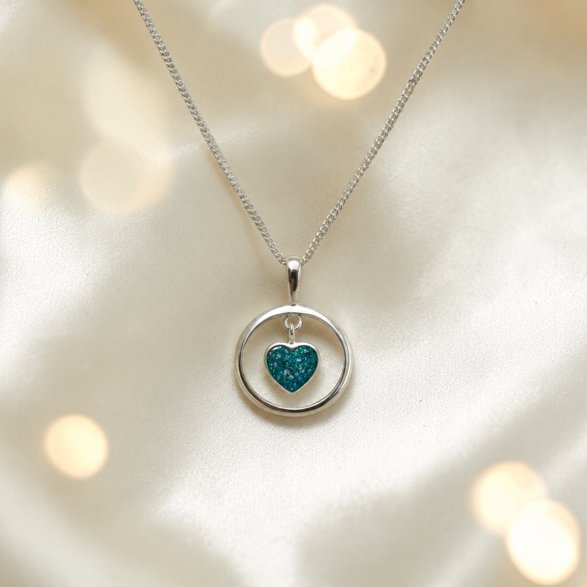 Wren silver open circle with heart drop ashes pendant in teal mist, handcrafted in Lancashire UK 