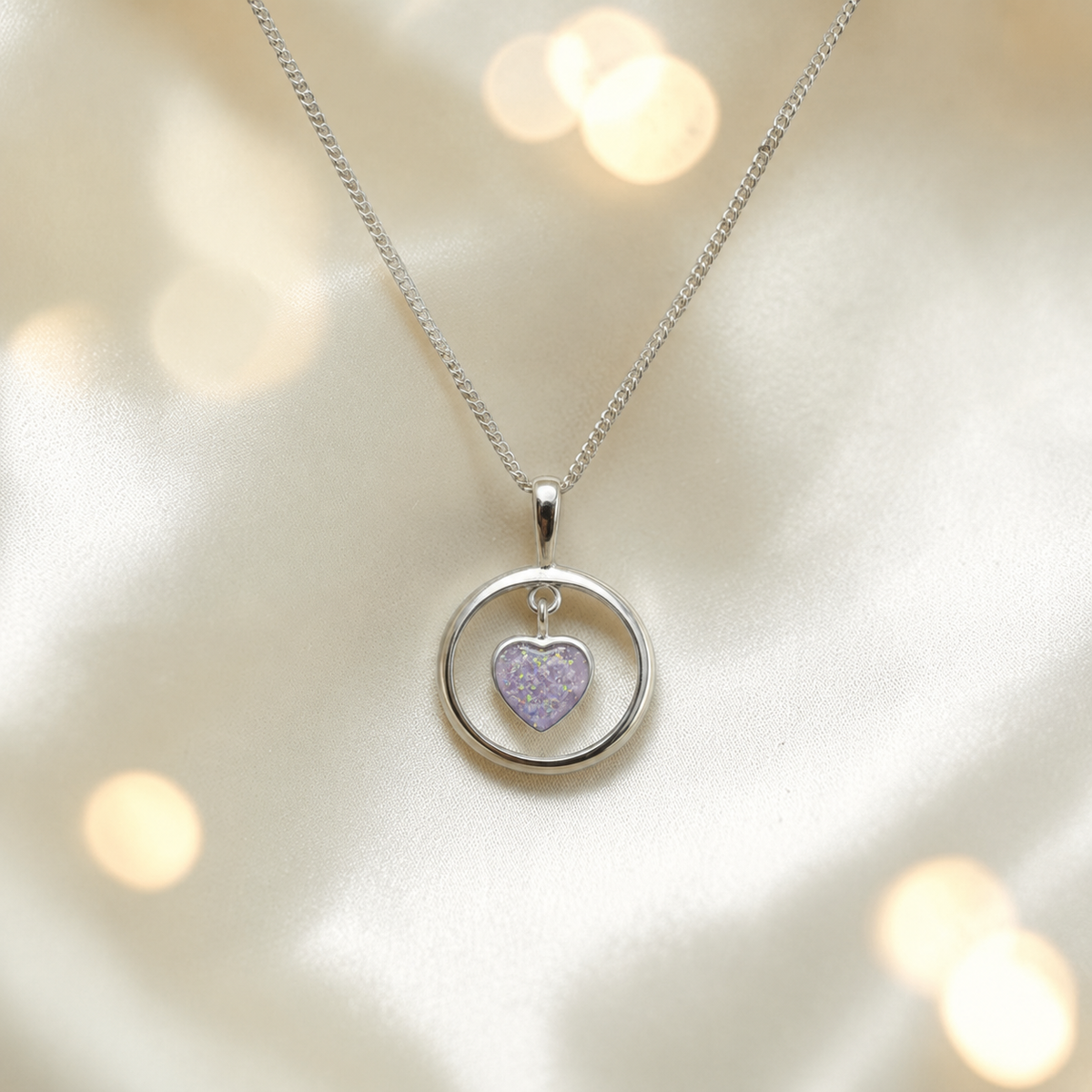 Wren silver open circle with heart drop ashes pendant in unicorn purple, handcrafted in Lancashire UK
