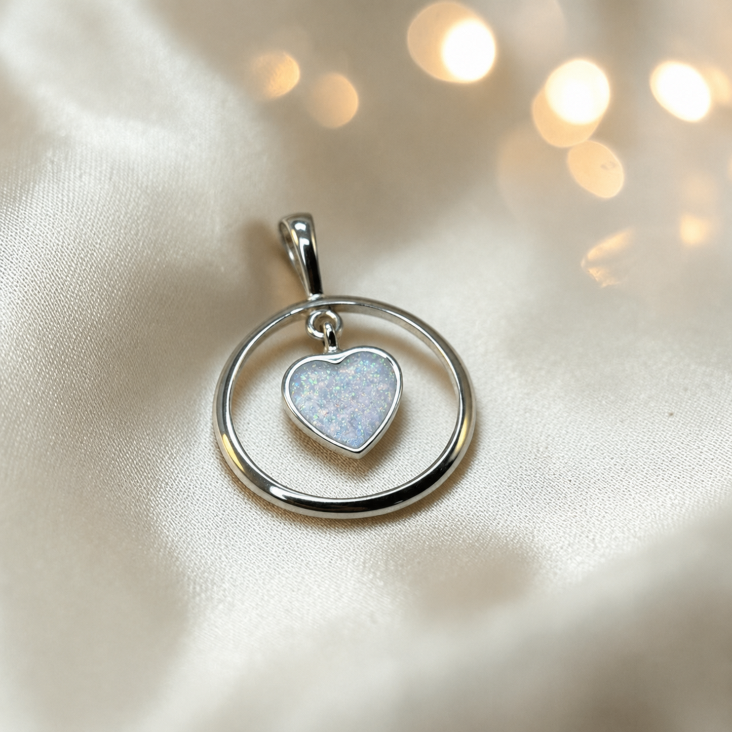 Silver memorial ashes pendant with a heart-shaped centre, handcrafted in lancashire